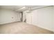 Spacious basement area with neutral carpet, painted walls, and access to stairs at 7691 Osage St, Denver, CO 80221