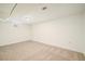 Finished basement features neutral carpet and painted walls with a small window at 7691 Osage St, Denver, CO 80221