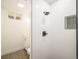 Modern bathroom featuring tiled shower with niche, rain shower head, and neutral vanity at 7691 Osage St, Denver, CO 80221