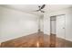 Bright bedroom features a modern ceiling fan, fresh paint, and sleek hardwood floors at 7691 Osage St, Denver, CO 80221