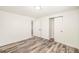 Bedroom has a large closet, fresh paint, and modern wood flooring at 7691 Osage St, Denver, CO 80221