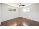 An empty bedroom features natural light and wood flooring at 7691 Osage St, Denver, CO 80221