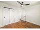 Bedroom featuring wood floors and a spacious closet at 7691 Osage St, Denver, CO 80221