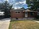 Charming brick home with mature trees and a well-maintained lawn at 7691 Osage St, Denver, CO 80221