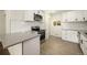 Bright kitchen is equipped with stainless steel appliances, quartz countertops and modern tile flooring at 7691 Osage St, Denver, CO 80221