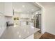 Modern kitchen with stainless steel appliances, quartz counters, white cabinets, and a subway tile backsplash at 7691 Osage St, Denver, CO 80221