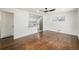 Bright living room featuring hardwood floors, a modern ceiling fan, and a pass-through to the updated kitchen at 7691 Osage St, Denver, CO 80221