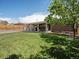 Spacious backyard with lawn, covered patio, privacy fence and mature tree at 8641 Rutgers St, Westminster, CO 80031