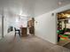 Finished basement area with carpet, bar, and open doorway to storage at 8641 Rutgers St, Westminster, CO 80031