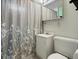 Modest bathroom with vanity, toilet, decorative shower curtain, and mirrored medicine cabinet at 8641 Rutgers St, Westminster, CO 80031