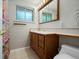 Bathroom with tiled floors, wooden vanity, and great lighting at 8641 Rutgers St, Westminster, CO 80031