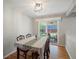 Bright dining room with sliding glass doors leading to a backyard patio and lovely wood flooring at 8641 Rutgers St, Westminster, CO 80031