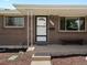 Close-up view of brick front exterior, front door, and updated features at 8641 Rutgers St, Westminster, CO 80031
