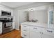 Bright kitchen with white cabinets, stainless steel appliances and hardwood floors at 8641 Rutgers St, Westminster, CO 80031