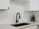 Modern kitchen with a deep stainless steel sink and matte black faucet, complemented by white subway tile backsplash at 8641 Rutgers St, Westminster, CO 80031