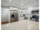 Updated kitchen features stainless steel appliances, white cabinetry, sleek countertops, and ample storage space at 8641 Rutgers St, Westminster, CO 80031