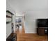 Open living area showcasing hardwood floors, television, and a glimpse of the dining room at 8641 Rutgers St, Westminster, CO 80031