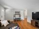 Spacious living room showcasing hardwood floors, television, and comfortable seating at 8641 Rutgers St, Westminster, CO 80031