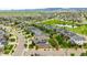 Stunning aerial view of a neighborhood with homes, green spaces, a pond, and picturesque scenery at 9567 Juniper Way, Arvada, CO 80007