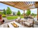 Back patio with a pergola, fire pit, and outdoor seating area at 9567 Juniper Way, Arvada, CO 80007