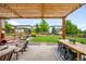 Cozy backyard patio with pergola, ample seating, lush lawn, and manicured landscaping at 9567 Juniper Way, Arvada, CO 80007