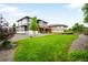 Expansive backyard with lush lawn, wooden fence, gravel area and an outdoor patio at 9567 Juniper Way, Arvada, CO 80007