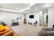 Spacious finished basement with exercise equipment, a seating area, and a large flat screen television at 9567 Juniper Way, Arvada, CO 80007
