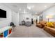 Finished basement showcasing a seating area, media area with a television, and a walk-in closet at 9567 Juniper Way, Arvada, CO 80007