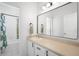 Bright bathroom with a large mirror, a single sink vanity, and a shower-tub combo at 9567 Juniper Way, Arvada, CO 80007