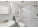 Clean bathroom featuring a glass-door shower, a vanity with a large mirror, and a white toilet at 9567 Juniper Way, Arvada, CO 80007