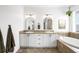 Elegant bathroom with double sinks, a soaking tub, and natural stone accents at 9567 Juniper Way, Arvada, CO 80007
