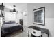 Modern bedroom featuring a gray bed, a wall art, and a desk at 9567 Juniper Way, Arvada, CO 80007