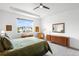 Comfortable bedroom with a large window for natural light and neutral tones creating a serene space at 9567 Juniper Way, Arvada, CO 80007