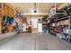 Spacious garage with organized storage, bikes, and a door to the house at 9567 Juniper Way, Arvada, CO 80007
