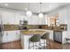 Modern kitchen features granite countertops, stainless appliances, and a convenient kitchen island at 9567 Juniper Way, Arvada, CO 80007