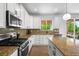 Beautifully updated kitchen with stainless steel appliances, granite countertops, and ample storage at 9567 Juniper Way, Arvada, CO 80007