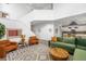 Open-concept living room with high ceilings and hardwood floors that lead into the kitchen at 9567 Juniper Way, Arvada, CO 80007