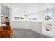 Bright loft area with a seating area, neutral-toned carpet, multiple windows, and modern lighting fixture at 9567 Juniper Way, Arvada, CO 80007