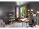 Well lit office with a modern desk, large window, and gray walls at 9567 Juniper Way, Arvada, CO 80007