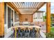 Inviting outdoor patio area with pergola, dining table, seating, and stylish decor at 9567 Juniper Way, Arvada, CO 80007