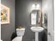 Small half bathroom with modern fixtures, gray walls and a white vanity at 9567 Juniper Way, Arvada, CO 80007