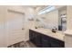 Bright bathroom with double sinks, dark cabinets, and plenty of counter space at 12685 W Montane Dr, Broomfield, CO 80021
