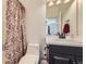 Bathroom featuring a stylish vanity, toilet, and shower with decorative curtain at 12685 W Montane Dr, Broomfield, CO 80021