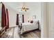 Cozy bedroom features a comfortable bed, neutral walls, wood-look flooring, and a ceiling fan at 12685 W Montane Dr, Broomfield, CO 80021