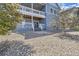 Exterior view of home featuring a covered patio, backyard, and professional landscaping at 12685 W Montane Dr, Broomfield, CO 80021