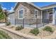 Close-up of a stone-accented home with a small front yard and decorative landscaping at 12685 W Montane Dr, Broomfield, CO 80021