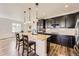Modern kitchen with dark cabinetry, a center island, and stainless steel appliances at 12685 W Montane Dr, Broomfield, CO 80021