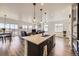 Open kitchen featuring a center island, stainless appliances, and a seamless flow to the living and dining areas at 12685 W Montane Dr, Broomfield, CO 80021