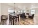 Spacious and open living area with a fireplace, dining table, and modern decor at 12685 W Montane Dr, Broomfield, CO 80021