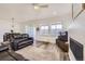 Open-concept living space with a fireplace, sleek hardwood floors, and ample natural light at 12685 W Montane Dr, Broomfield, CO 80021